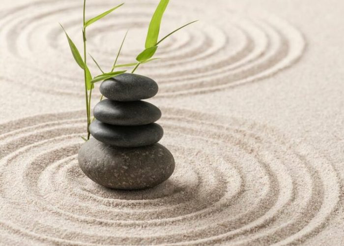 stacked-zen-stones-sand-background-art-of-balance-concept